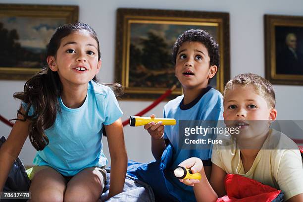 elementary students having slumber party at art gallery - art gallery party stock pictures, royalty-free photos & images
