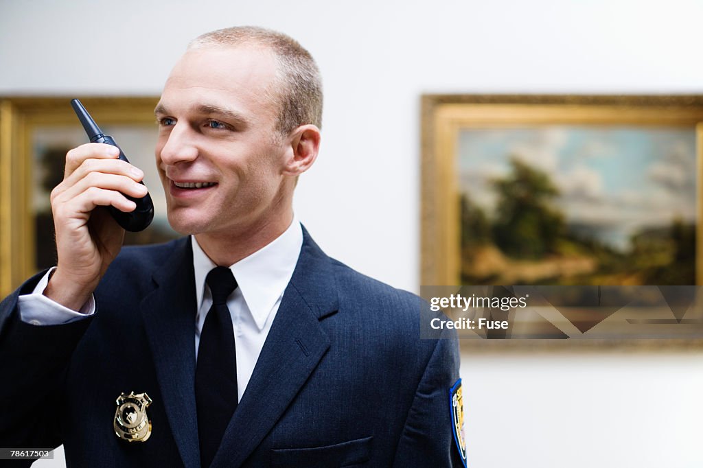 Security Guard Using Walkie-talkie at Art Gallery