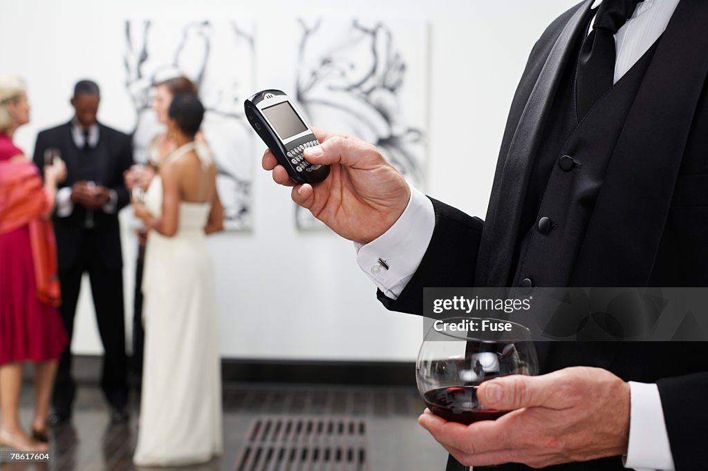 Man Using PDA at Art Gallery