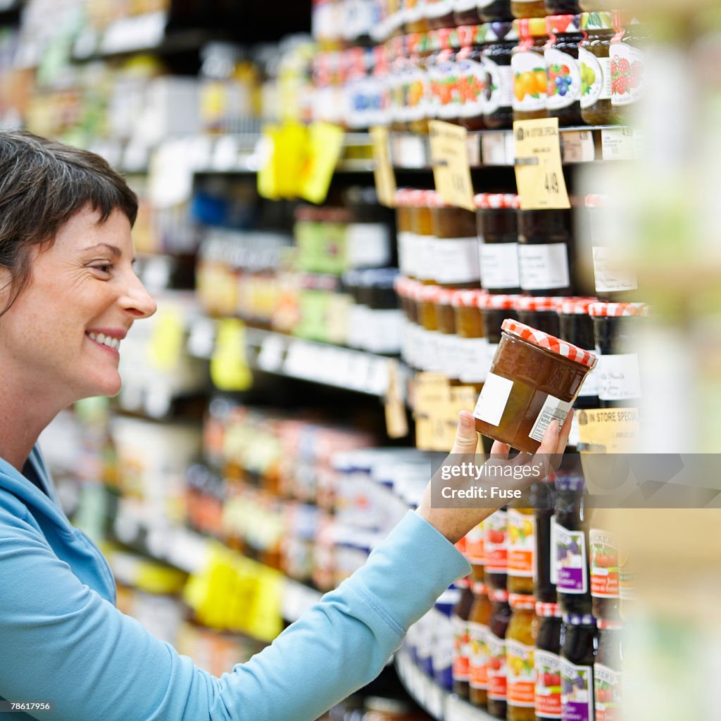 Woman Selecting Jam at Store