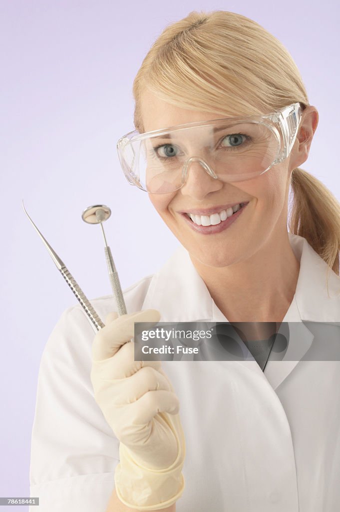 Woman Holding Dental Instruments