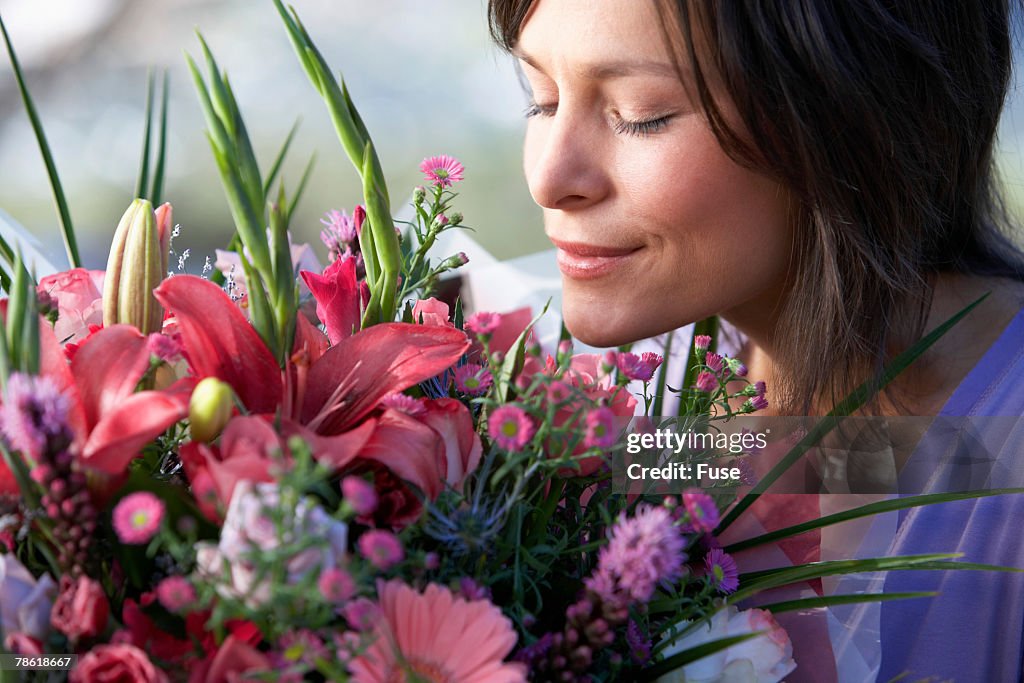 Young Woman Smelling Bouquet