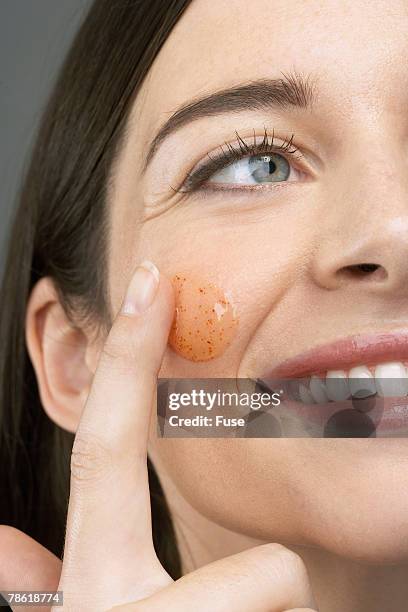 woman using facial scrub - exfoliation face stock pictures, royalty-free photos & images