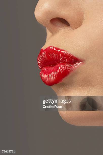 woman wearing red lipstick - red lipstick kiss stock pictures, royalty-free photos & images