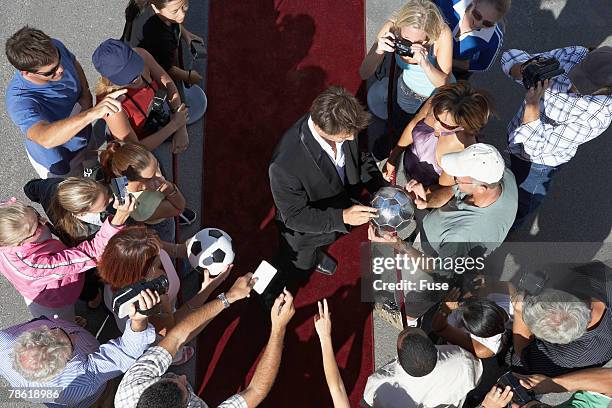 fans getting autographs from soccer star - autograph football stock pictures, royalty-free photos & images