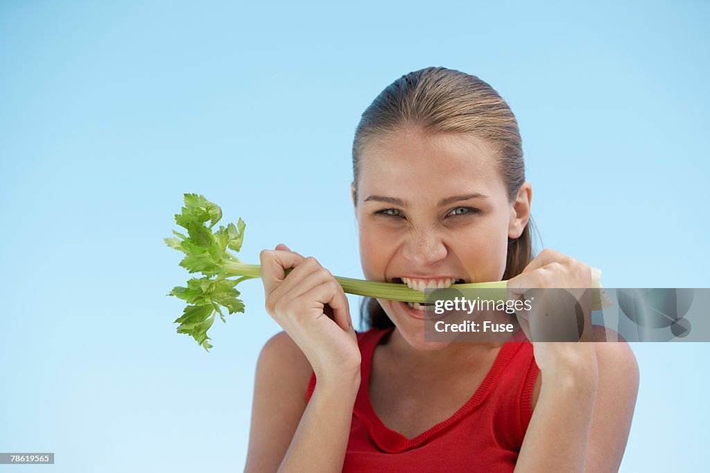 Young Woman Eating Celery