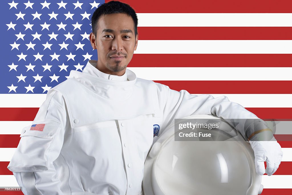 Man in Astronaut Suit in Front of American Flag