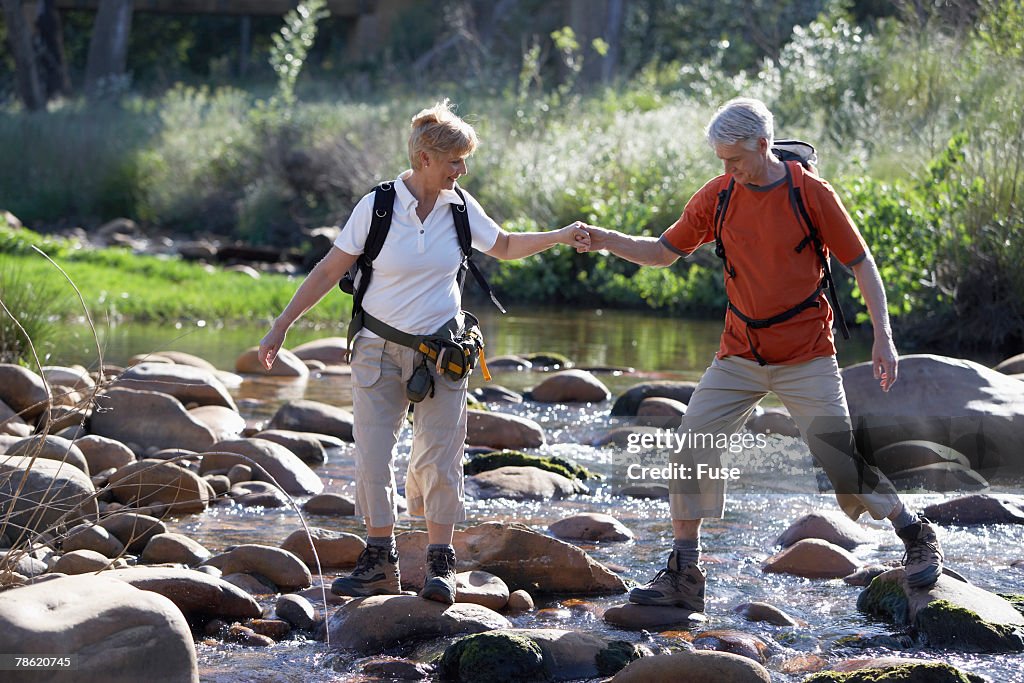 Hikers Crossing Stream