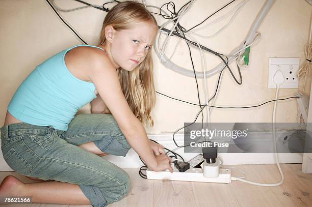 girl using surge protector - power strip stock pictures, royalty-free photos & images