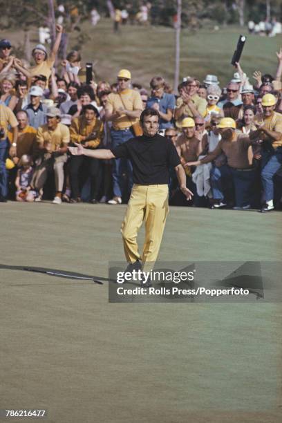 English professional golfer Tony Jacklin drops his putter on a green in celebration during competition to win the 1970 US Open Championship golf...