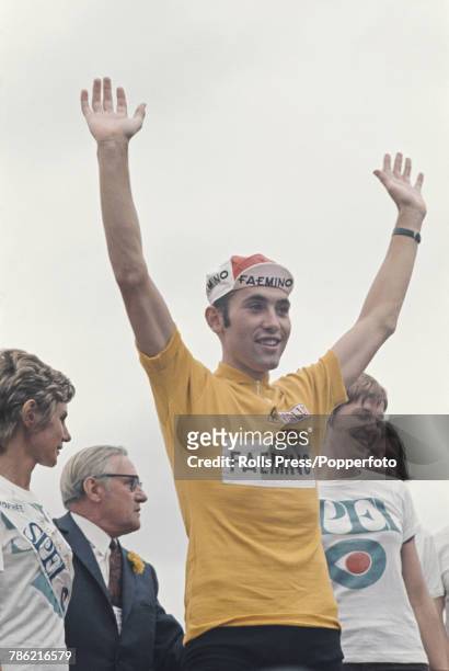Belgian racing cyclist Eddy Merckx of the Faemino-Faema cycling team raises his arms in the air in celebration after finishing in first place to win...