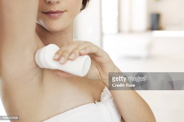 woman applying deodorant - deodorant stock pictures, royalty-free photos & images