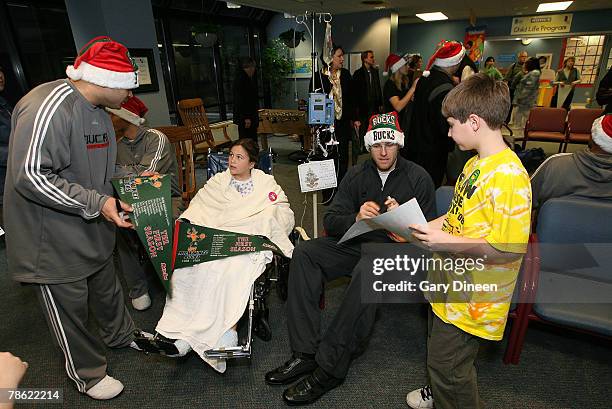 Assistant coach Jarinn Akana and Jake Voskuhl of the Milwaukee Bucks visit with patients and their families at the MACC Fund Cancer Center and...