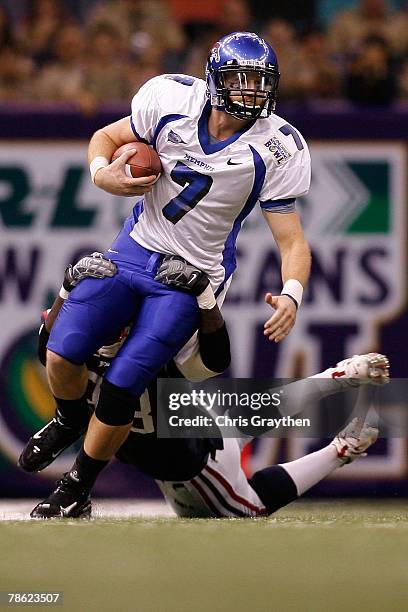 Will Hudgens of the Memphis University Tigers is sacked by Robert St. Clair of the Florida Atlantic University Owls in the New Orleans Bowl on...