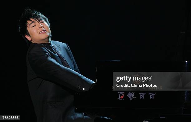 Chinese Pianist Lang Lang performs during his New Year Piano Solo Concert at the Chongqing People's Great Hall on December 21, 2007 in Chongqing...