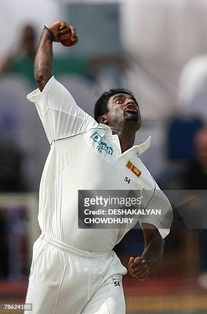 Sri Lankan bowler Muttiah Muralitharan delivers a ball to England batsman Alastair Cook during the fifth and final day of the third and final Test...