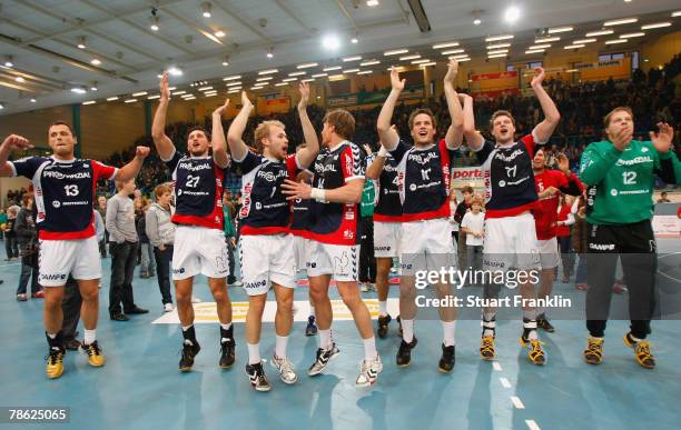 The players of Flensburg celebrate their win after the Bundesliga game between GWD Minden and SG Flensburg-Handewitt on December 22, 2007 in Minden,...