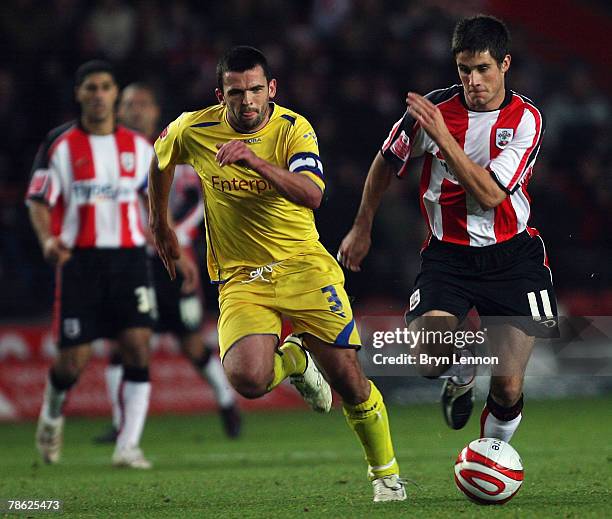 Andrew Surman of Southamptonis challenged by Callum Davidson of Preston North End during the Coca-Cola Championship match between Southampton and...
