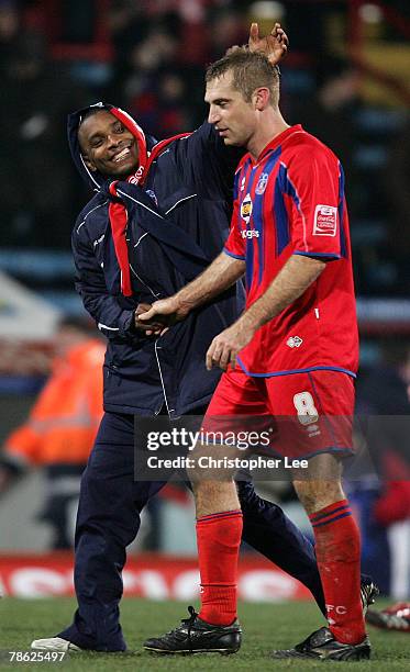 Happy and well wrapped up Clinton Morrison of Palace congratulates James Scowcroft for his goal at the end of the match during the Coca-Cola...