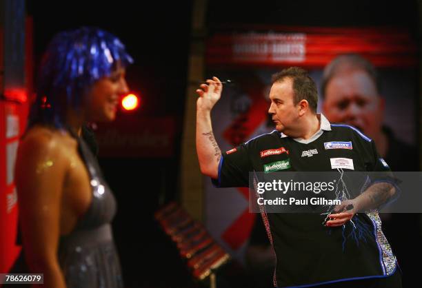 Phil Taylor of England throws a dart during the second round match between Phil Taylor of England and Mark Walsh of England during the 2008...