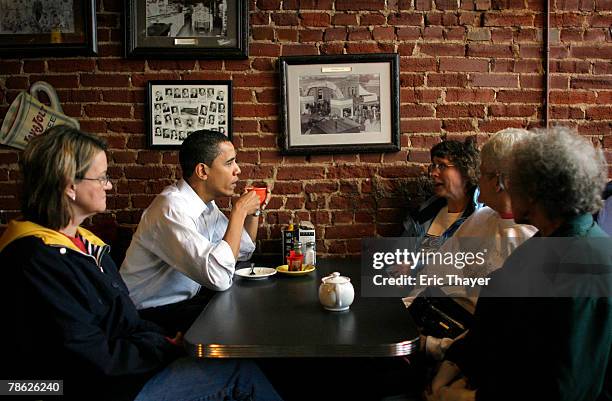 Democratic presidential candidate Senator Barack Obama talks with customers at Smokey Row coffee shop December 22, 2007 in Pleasantville, Iowa. Obama...