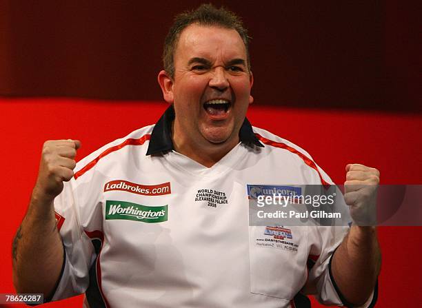 Phil Taylor of England celebrates winning the second round match between Phil Taylor of England and Mark Walsh of England during the 2008...