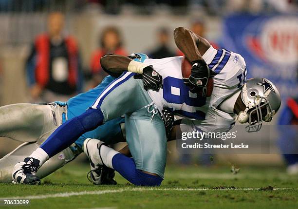 Terrell Owens of the Dallas Cowboys is injured as he is tackled by Jon Beason of the Carolina Panthers in the 2nd quarter during their game at Bank...