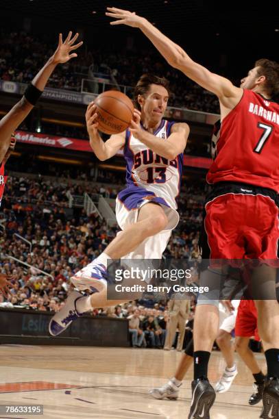 Steve Nash of the Phoenix Suns passes around Andrea Bargnani of the Toronto Raptors in an NBA game played on December 22, 2007 at U.S. Airways Center...
