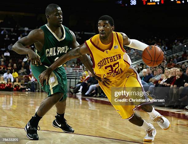 Mayo of the USC Trojans drives with the ball past Dawin Whiten of the Cal Poly Mustangs during the game at the Galen Center December 22, 2007 in Los...