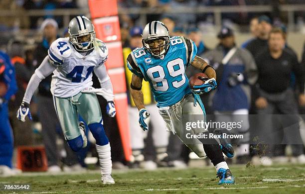 Steve Smith of the Carolina Panthers picks up a first down as Terence Newman of the Dallas Cowboys works to run him down at Bank of America Stadium...