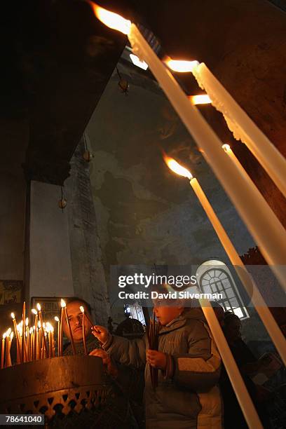 Palestinian boy lights candles in the Church of the Nativity, which according to tradition stands over the Grotto where Jesus was born, December 23,...