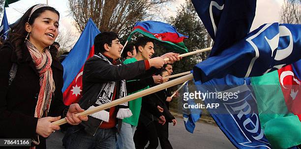 Young supporters of the pro-President movement Ireli carry flags during their rally celebrating the 46th bithday of Azerbaijan's President Ilkham...