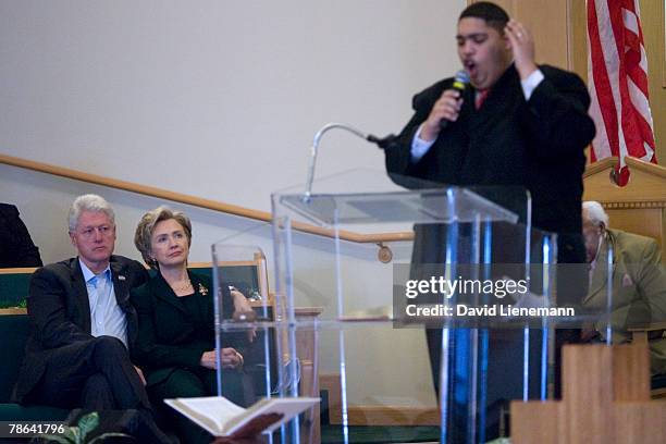 Former president Bill Clinton and his wife, Democratic presidential hopeful Hillary Clinton listen to Reverend Frantz Whitfield preach during...