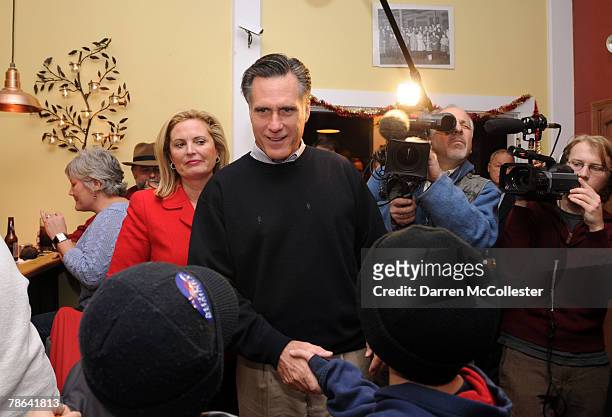 Republican presidential candidate and former Massachusetts Gov. Mitt Romney and wife Ann speak with diners at Nonni's Italian Eatery December 23,...