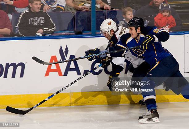St. Louis Blues right wing Mike Johnson checks Atlanta Thrashers left wing Pascal Dupuis on December 23, 2007 at Scottrade Center in St. Louis,...