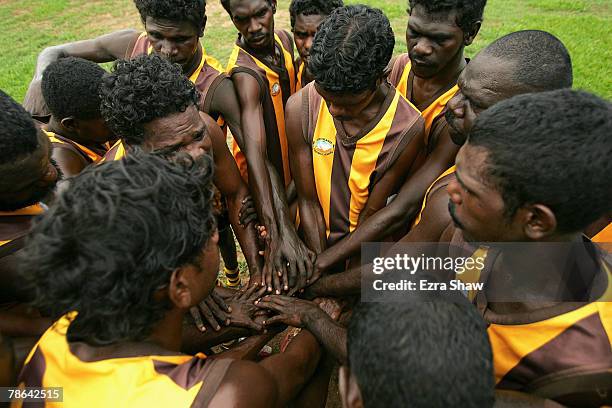 The Tapalinga Super Stars huddle together in between quarters of their match against the Muluwurri Magpies in a game of Australian Rules football at...