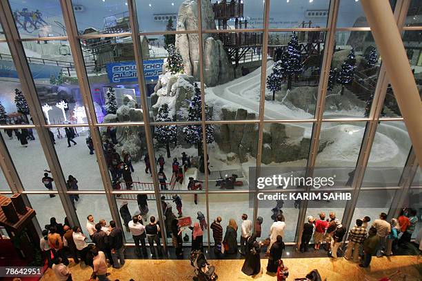 Emiratis look at the Christmas decorations at Ski Dubai, a 300 square meter indoor "Snow Park", in the Mall of the Emirates, 24 December 2007. AFP...