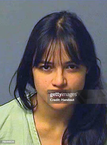 In this handout image provided by the Los Angeles County Sheriff's Department, actress Michelle Rodriguez poses for her mug shot photo after she...