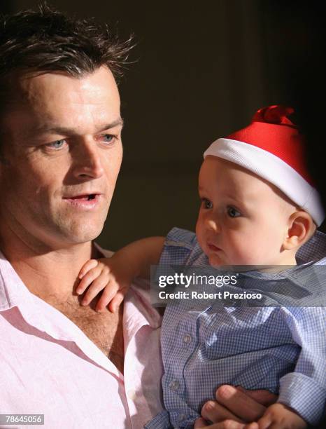 Adam Gilchrist with 10 month old Archie pose during the Australian cricket team Christmas lunch at Crown Casino on December 25, 2007 in Melbourne,...