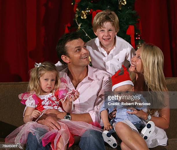 Adam Gilchrist and wife Mel and their children Annie, Harry and Archie pose during the Australian cricket team Christmas lunch at Crown Casino on...