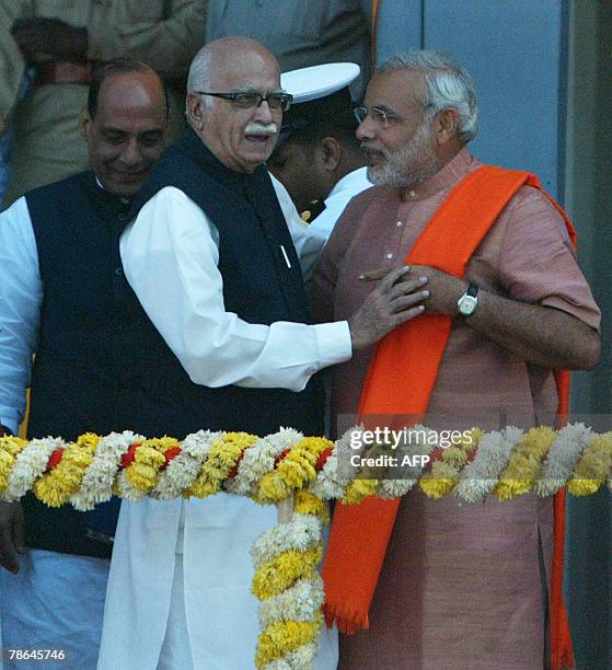 Chief Minister of western India's Gujarat state, Narendra Modi, and L.K.Advani, a senior Bhartiya Janta Party leader discuss while behind is Rajnath...