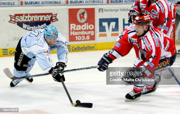 Brad Smith of Hamburg competes with Andre Renkel of Berlin during the DEL match between Hamburg Freezers and Eisbaeren Berlin at the Color Line Arena...