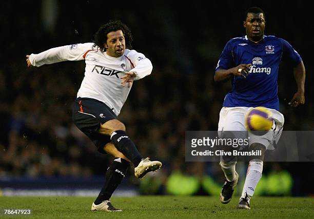 Ivan Campo of Bolton Wanderers shoots watched by Joseph Yobo of Everton during the Barclays Premier League match between Everton and Bolton Wanderers...