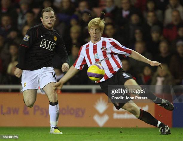 Wayne Rooney of Manchester United clashes with Paul McShane of Sunderland during the Barclays FA Premier League match between Sunderland and...