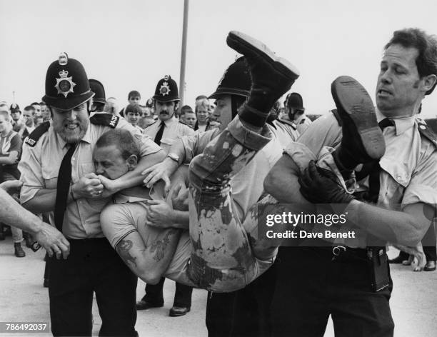 Police restraining a skinhead during a disturbance in Southend-on-Sea, Essex, 1st September 1981.