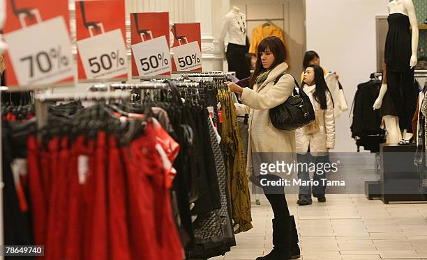 Shoppers look for sale items in an H & M store December 26, 2007 in New York City. Deep discounts were being offered nationwide by retailers on the...