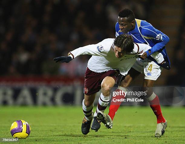 Lauren of Portsmouth pulls back Tomas Rosicky of Arsenal during the Barclays Premier League match between Portsmouth and Arsenal at Fratton Park on...