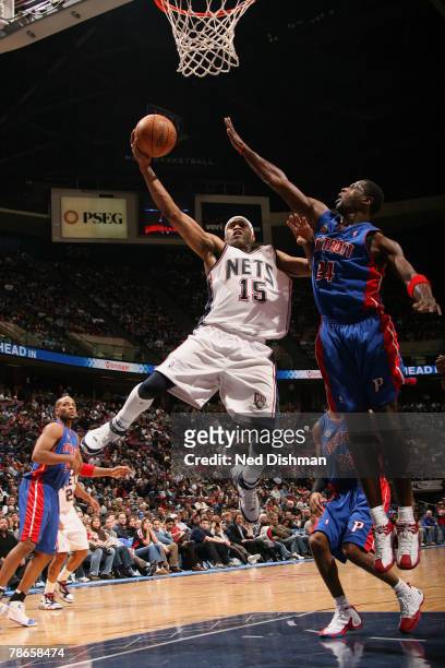Vince Carter of the New Jersey Nets shoots against Antonio McDyess of the Detroit Pistons on December 26, 2007 at the Continental Airlines Arena in...
