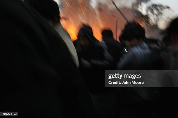 Survivors flee a bomb blast attack on former Prime Minister Benazir Bhutto December 27, 2007 following a campaign rally in Rawalpindi, Pakistan. The...