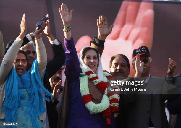 Former Prime Minister Benazir Bhutto waves to supporters at a campaign rally minutes before she was assassinated in a bomb attack December 27, 2007...